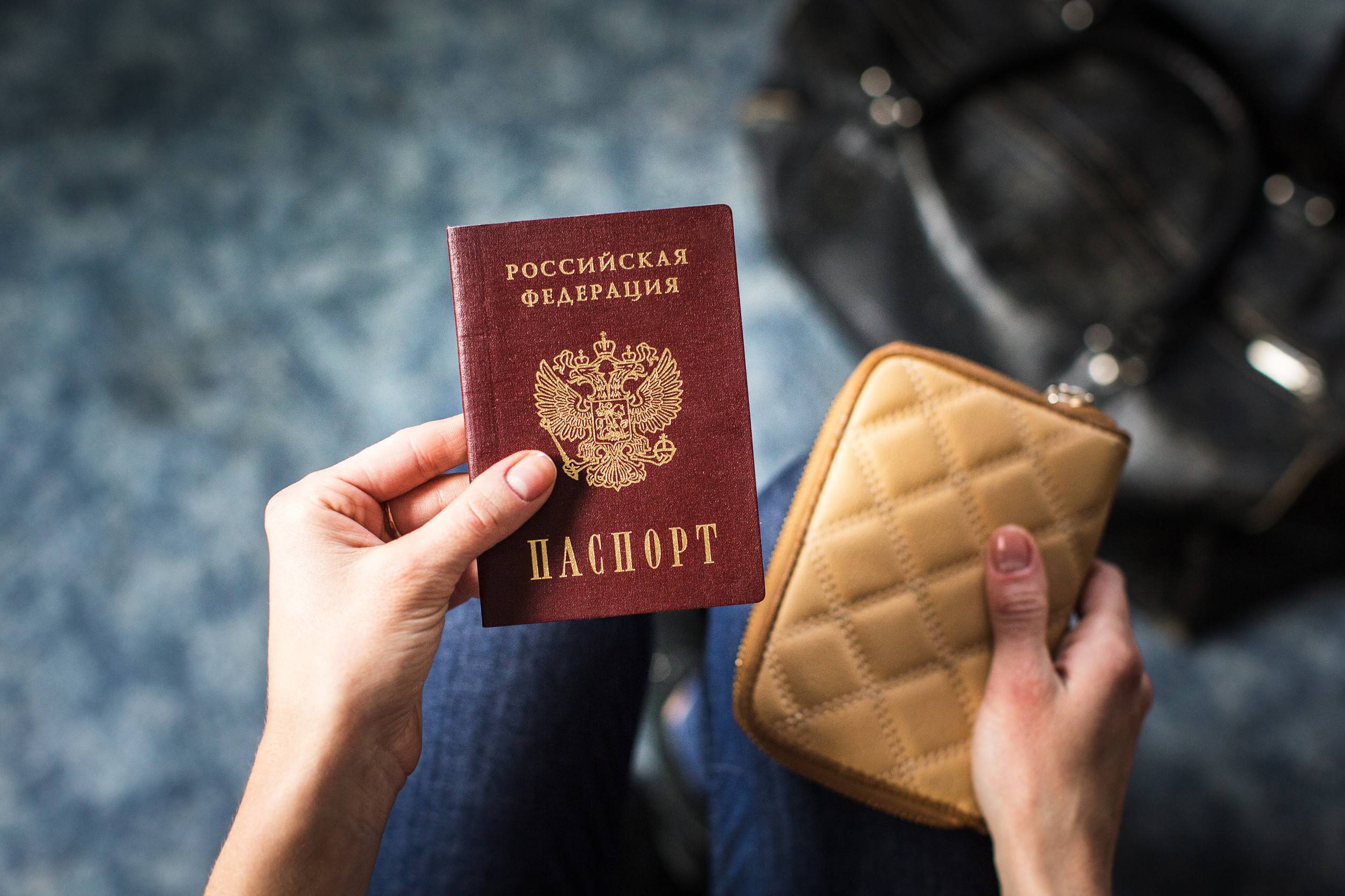 Girl holding Russian passport and purse