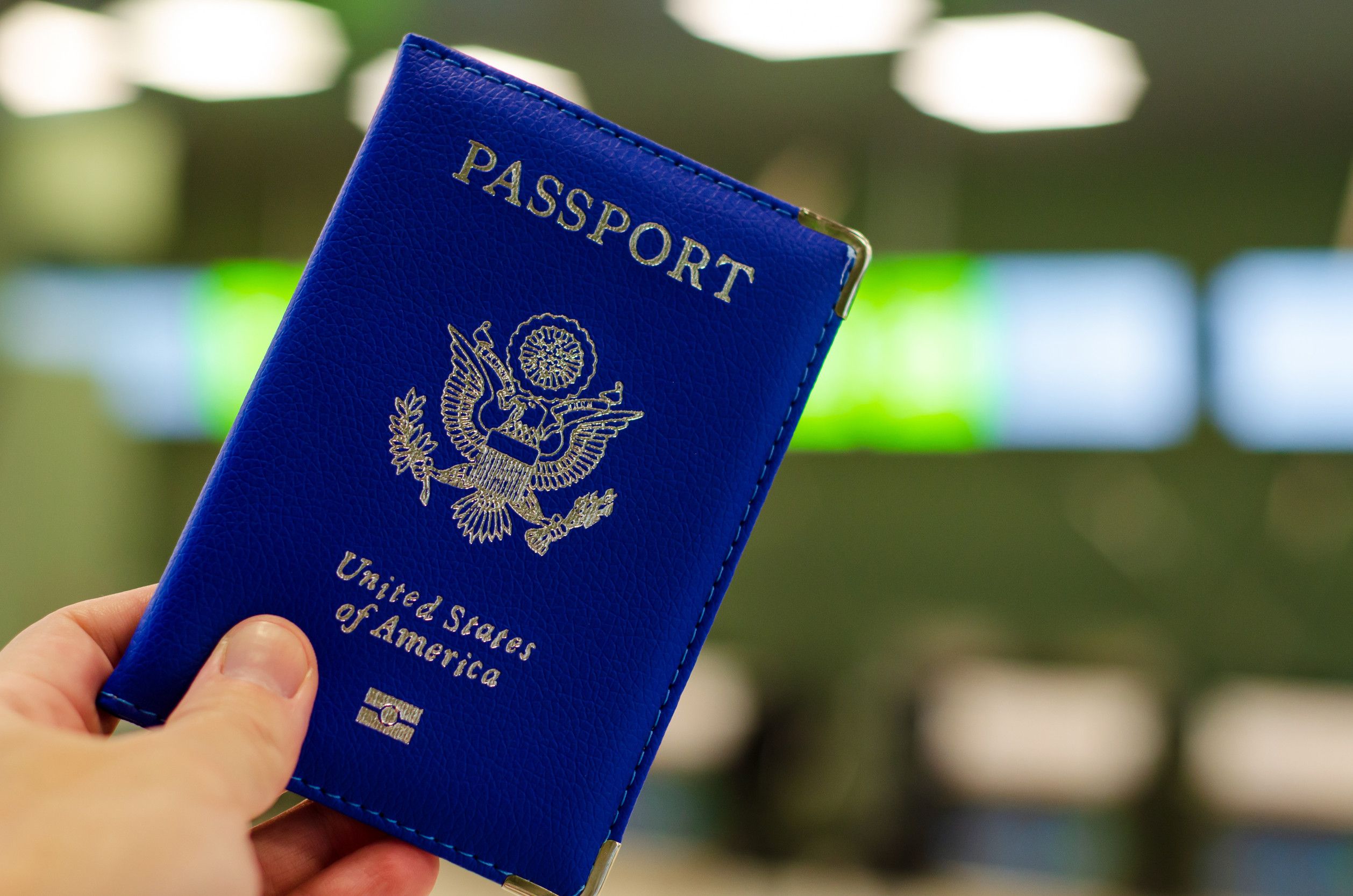 Hand holding U.S. passport in the airport
